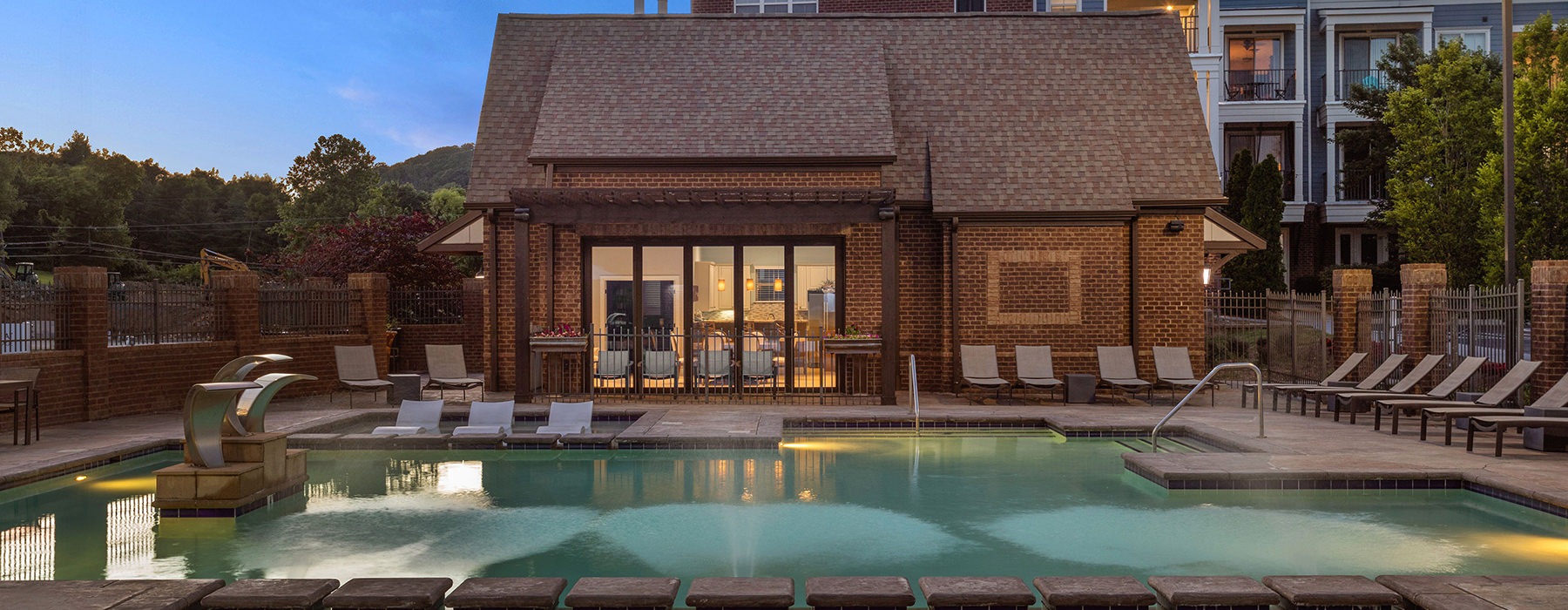 Large sparkling pool with large pool deck and lounge chairs