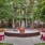 a courtyard with red chairs and a fountain in it