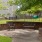 a bench and a chair in a park